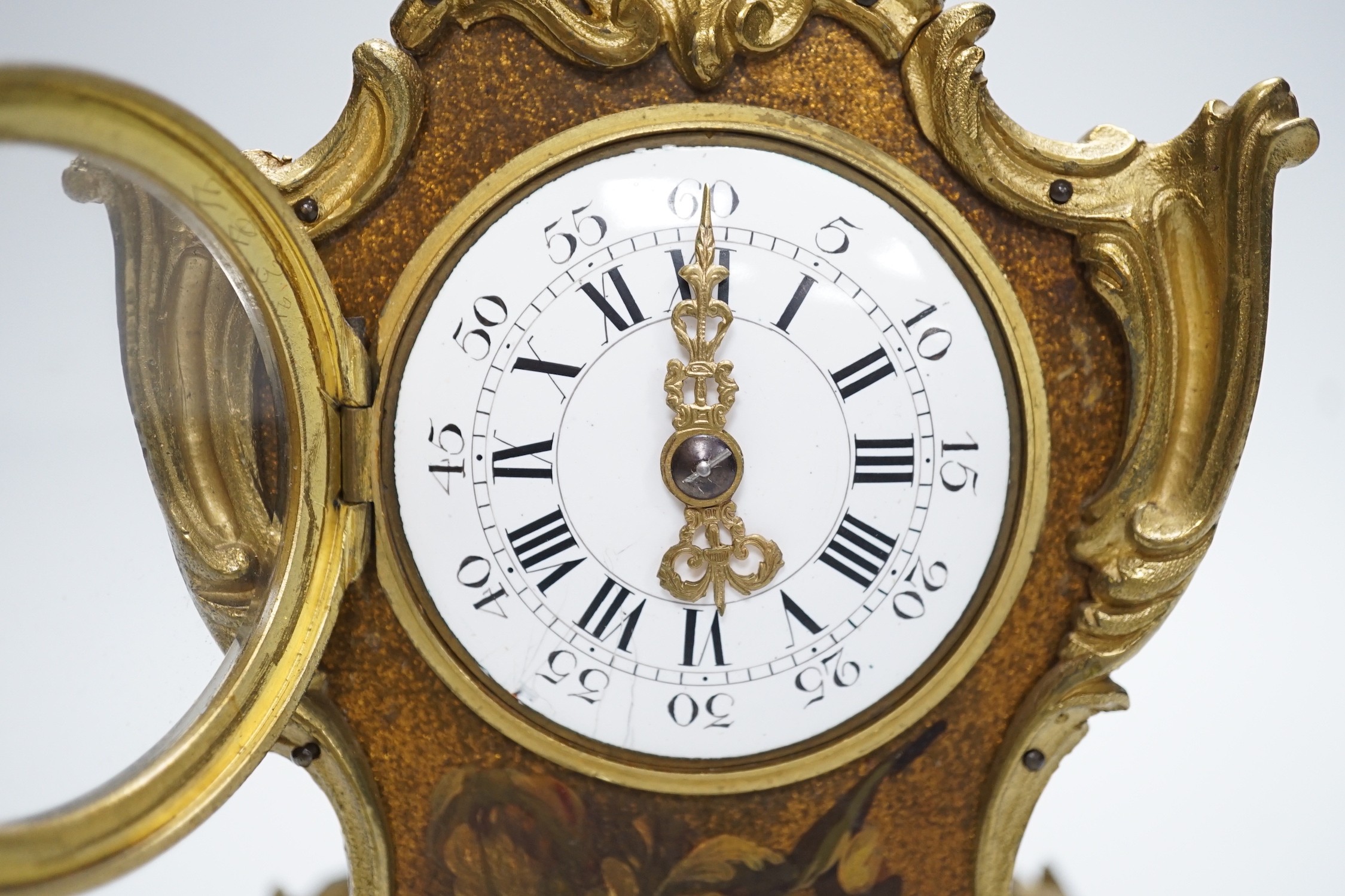 An early 20th century French gilt metal mounted painted mantel timepiece, 25cm
